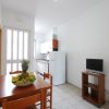 Cucina con tavolo, frutta e TV su carrello.